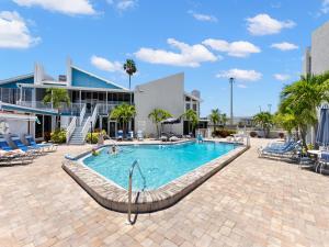 a pool at a resort with chairs and a building at Madeira Beach Yacht Club 247g in St Pete Beach