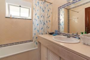 a bathroom with a sink and a shower at Praia del Rey Golf & Beach Resort - T3 in Amoreira +22 photos