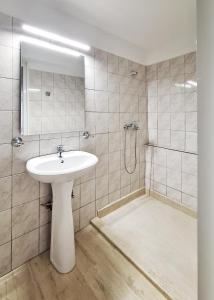 a bathroom with a sink and a shower at Achlia Sea Side Retreat 3 in Achlia