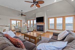 a living room with a couch and a fireplace at 7042 - Whistling Oyster by Resort Realty in Rodanthe