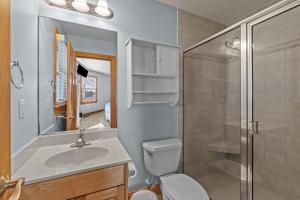 a bathroom with a toilet and a sink and a shower at 7042 - Whistling Oyster by Resort Realty in Rodanthe