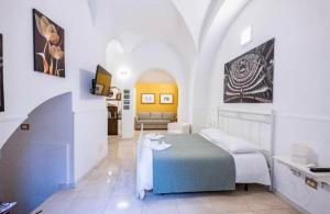 a bedroom with a bed and a couch in a room at I SICANI HOUSE AND MORE in Catania