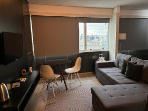 a living room with a couch and a table at HOTEL SHOPPING VILA OLIMPIA in Sao Paulo