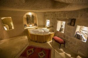 a large bathroom with a tub and a mirror at Kistar Cave Hotel in Uçhisar +141 photos