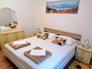 a bedroom with a large white bed with two night stands at Apartman TRALJE in Senj