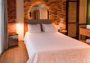 Postel nebo postele na pokoji v ubytování Nomada Hotel Origen