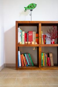 a book shelf filled with lots of books at Sardinian Gallery Porto in Porto Alabe