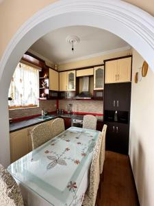 a kitchen with a table and chairs in a kitchen at Joen Apartment 3 in Sarandë