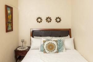 a bedroom with a bed with two mirrors on the wall at BreakFast Incl Adorable1BCottage Walk to the beach in Priory