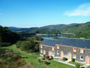 an aerial view of a large house with a lake at Oasis de détente à la montagne accès lac 5 minutes in La Salvetat