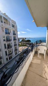 a balcony of a building with a view of the ocean at Ref ILES - Palmes d'Or Properties in Cannes