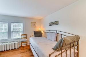 a bedroom with a bed and a chair and a window at Montour Falls Home 2 Mi to Seneca Lake and Wineries in Montour Falls +32 photos