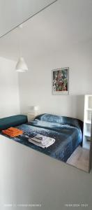 a bedroom with a bed with a blue blanket at LoVe House - Apartment on the beach in Pescara