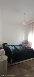 a bedroom with a bed with a black comforter at LoVe House - Apartment on the beach in Pescara