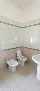 a bathroom with a toilet and a sink at LoVe House - Apartment on the beach in Pescara