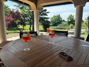 three wine glasses sitting on a wooden table at Landhaus Pannonia in Trausdorf an der Wulka