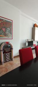 a room with a table and red chairs and a picture at LoVe House - Apartment on the beach in Pescara