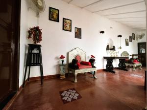 a living room with a red couch and a fireplace at Villa Mon Cheri in Pondicherry