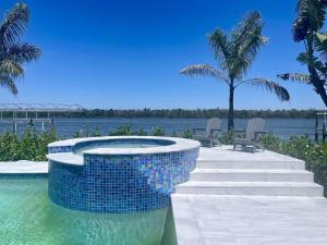 a swimming pool with a fountain in the water at 3891 Bayside in Fort Myers Beach