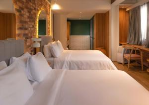 Postel nebo postele na pokoji v ubytování Nomada Hotel Origen