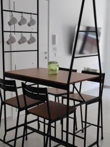 a dining room table and chairs with lights at AM Chinorros Square. in Fuengirola