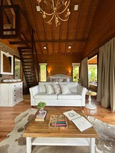 a living room with a white couch and a table at Vallée Cabanas in Urubici