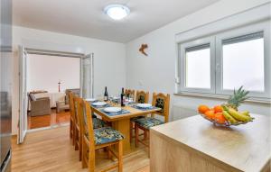 a dining room with a table with a bowl of fruit on it at Pet Friendly Home In Zagreb in Dolje