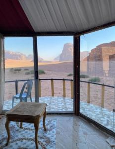 a room with a table and a view of the desert at joy of life in Wadi Rum