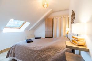 a bedroom with a large bed and a skylight at Face a la mer avec terrasse ensoleillee Brehec in Plouha