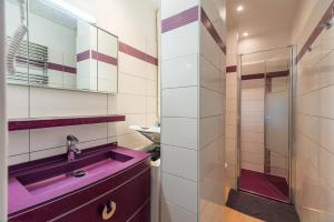 a bathroom with a purple sink and a shower at Face a la mer avec terrasse ensoleillee Brehec in Plouha +17 photos