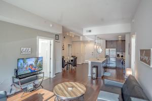 uma sala de estar com um sofá, uma televisão e uma cozinha em Buckhead Fully Furnished Apartment apts em Atlanta
