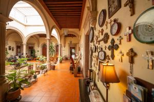 a hallway in a building with clocks on the walls at Hotel Posada San Agustin in Durango
