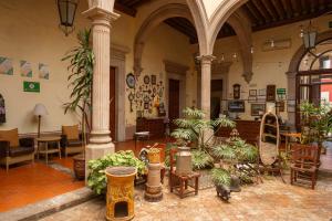 a room filled with lots of plants in a building at Hotel Posada San Agustin in Durango