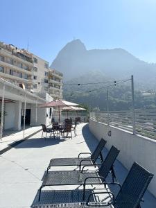 a group of chairs and tables on a balcony at CoVivere - RJ in Rio de Janeiro