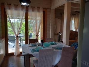 a dining room table with a white table cloth and chairs at WOODEN HOUSE in Preveza