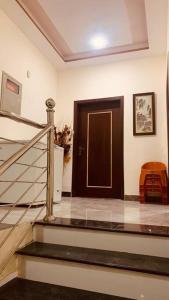 a staircase with a door in a room with a stair case at Exotic Hill View Stay in Karachi