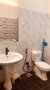 a bathroom with a toilet and a sink at Exotic Hill View Stay in Karachi