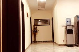 a hallway with a refrigerator in a building at Exotic Hill View Stay in Karachi