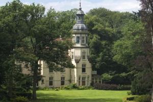 a building with a tower on top of a field at Veluwe Luxe Glamping In de natuur voor 6 personen LL94 in Putten