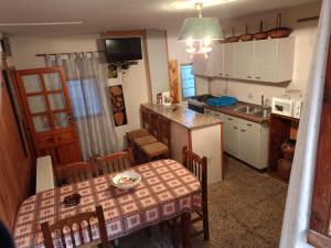 a kitchen and dining room with a table and a table and chairs at Casa Demetrio in Mirambel