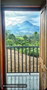 a view of a mountain from a window at Galaxy villa in Wayanad