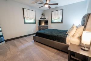 a bedroom with a bed and a flat screen tv at New Listing! Boho Mountain Getaway - 2 Bed, 2 Bath in Dahlonega