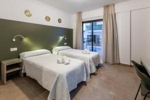 Cama o camas de una habitación en Hostal Alicante