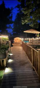 a wooden walkway with lights on it at night at Country Roads cabin in Jamestown