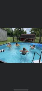 a group of people swimming in a swimming pool at Country Roads cabin in Jamestown