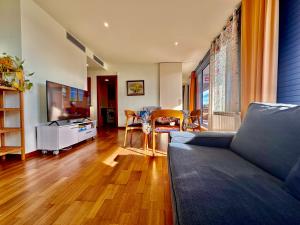 ein Wohnzimmer mit einem Sofa und einem Tisch in der Unterkunft Claire perfect vilanova penthouse by hlclub agency in Vilanova i la Geltrú
