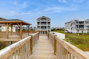a wooden boardwalk leading to a beach house at Topsail Tower in North Topsail Beach
