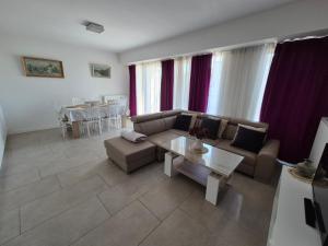 a living room with a couch and a table at BIG 21 Old Town LUX Apartment, self check-in 24h, free parking in Poznań