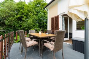 a wooden table and chairs on a patio at Ferienhaus Mitzi in Floing