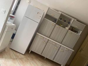 a white refrigerator in a kitchen with its doors open at Dar nour in Les Abrets en Dauphine